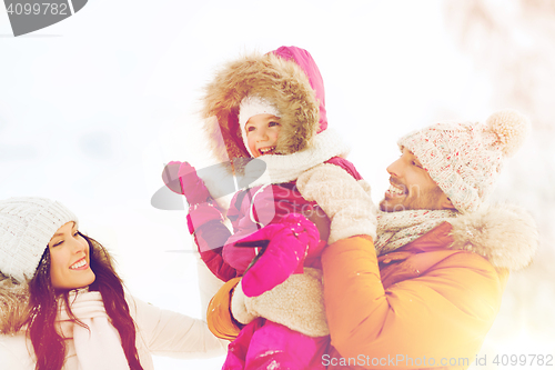 Image of happy family with child in winter clothes outdoors