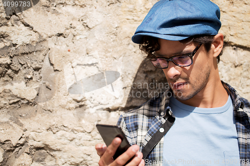 Image of hipster man texting message on smartphone