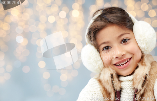 Image of happy little girl wearing earmuffs