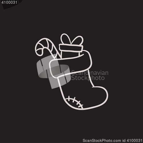 Image of Christmas boot with gift and candy sketch icon.
