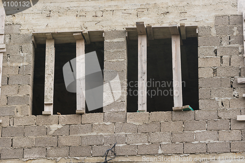 Image of Wooden braces put in the window opening when building a house