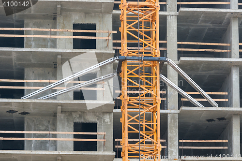 Image of Mounting construction crane lifting to overlaps in the construction of the house