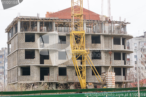 Image of Abandoned building a house, next to the house is abandoned crane