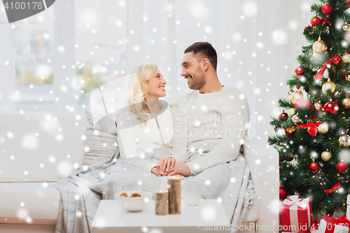 Image of happy couple at home with christmas tree