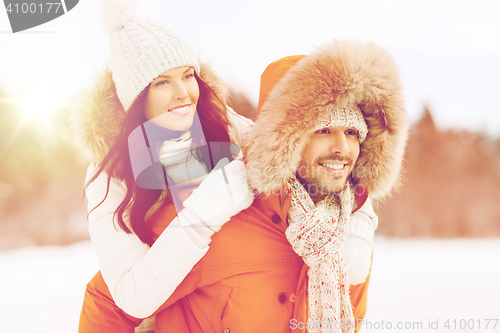 Image of happy couple having fun over winter background