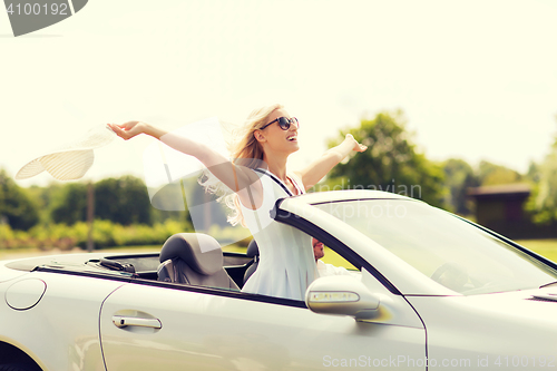 Image of happy man and woman driving in cabriolet car