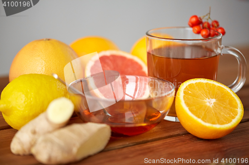 Image of tea with honey, lemon and ginger on wood