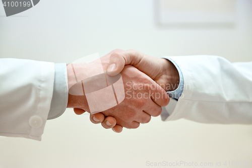 Image of close up of doctors hands making handshake