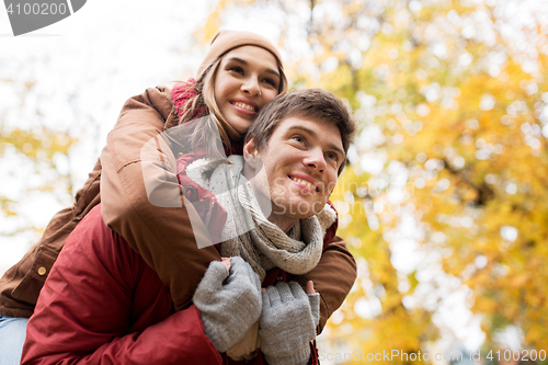 Image of happy young couple having fun in autumn park