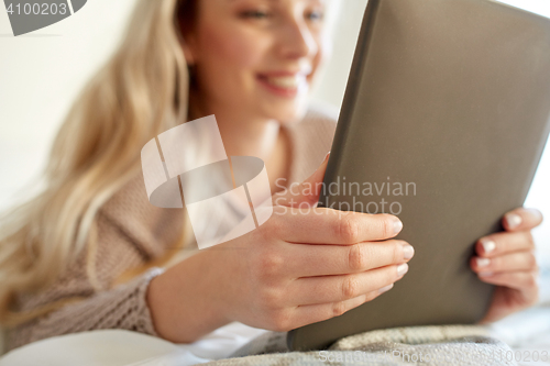 Image of close up of young woman with tablet pc at home