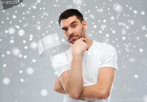 Image of man thinking over snow background