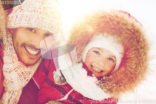 Image of happy family in winter clothes outdoors