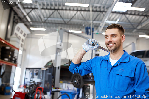 Image of auto mechanic or smith with wrench at car workshop