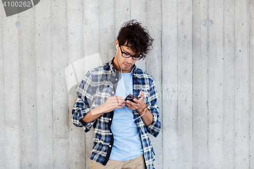 Image of man with earphones and smartphone listening music