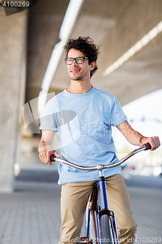 Image of young hipster man riding fixed gear bike