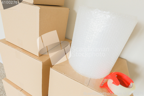 Image of Variety of Packed Moving Boxes In Empty Room