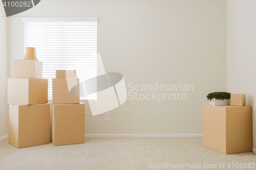 Image of Variety of Packed Moving Boxes In Empty Room