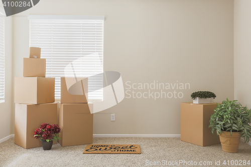 Image of Variety of Packed Moving Boxes In Empty Room