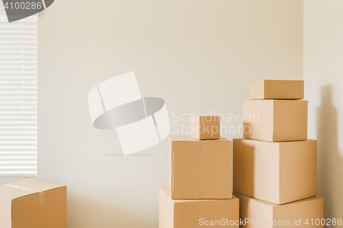 Image of Variety of Packed Moving Boxes In Empty Room