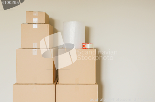 Image of Variety of Packed Moving Boxes In Empty Room