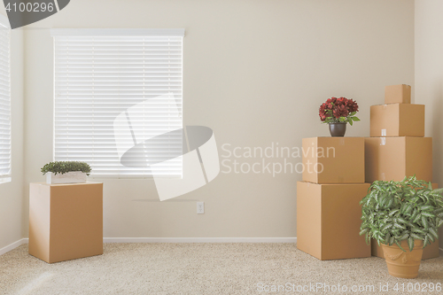 Image of Variety of Packed Moving Boxes In Empty Room