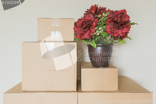 Image of Variety of Packed Moving Boxes In Empty Room