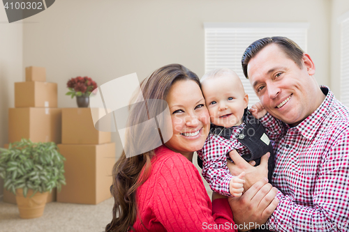 Image of Caucasian Family with Baby In Room with Moving Boxes