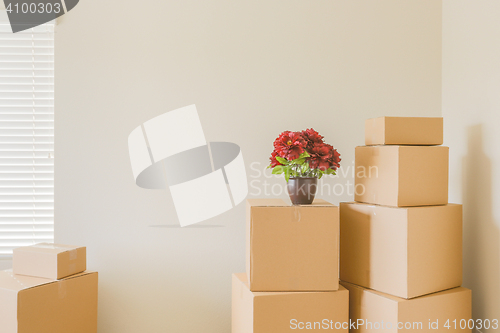 Image of Variety of Packed Moving Boxes In Empty Room