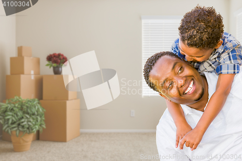 Image of Mixed Race African American Father and Son In Room with Packed M