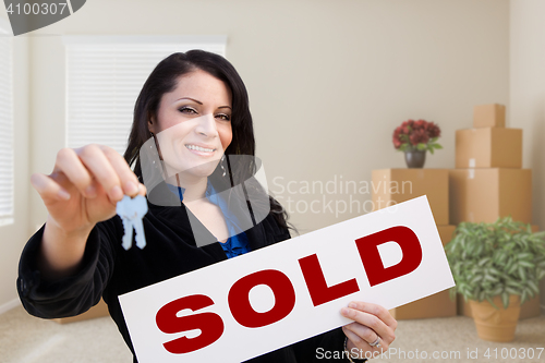 Image of Hispanic Female Real Estate Agent with Sold Sign and Keys in Roo