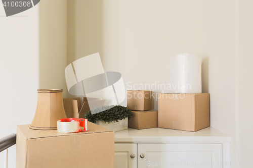 Image of Variety of Packed Moving Boxes In Empty Room