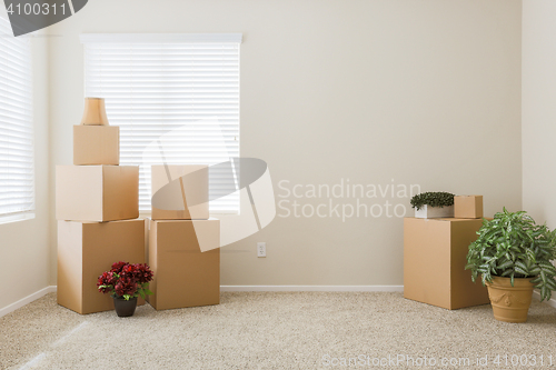 Image of Variety of Packed Moving Boxes In Empty Room