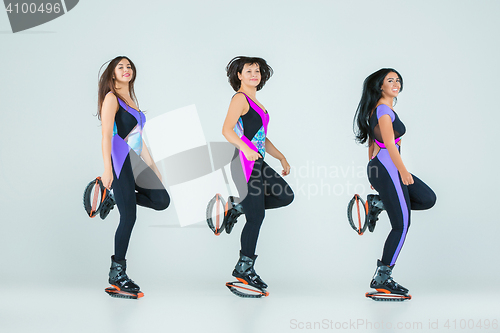 Image of The group of girls, jumping on kangoo training