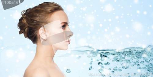 Image of beautiful young woman face over water and snow