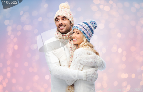 Image of smiling couple in winter clothes hugging