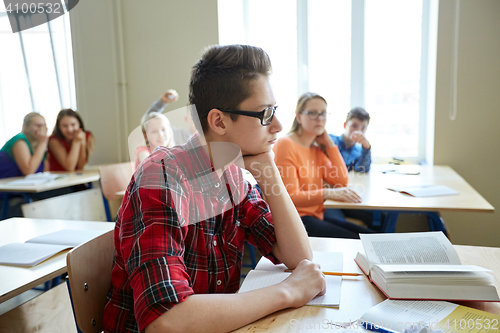 Image of students gossiping behind classmate back at school