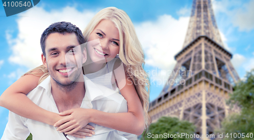 Image of happy couple having fun over eiffel tower