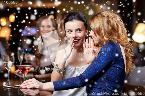 Image of happy women with drinks at night club