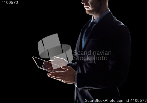 Image of close up of businessman with transparent tablet pc