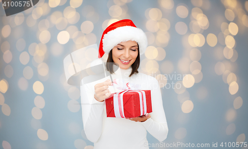 Image of smiling woman in santa helper hat with gift box