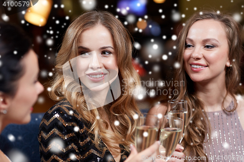 Image of happy women with champagne glasses at night club