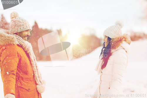 Image of happy couple walking over winter background