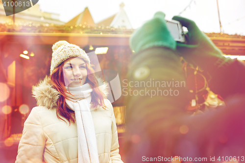 Image of couple taking picture with camera in old town