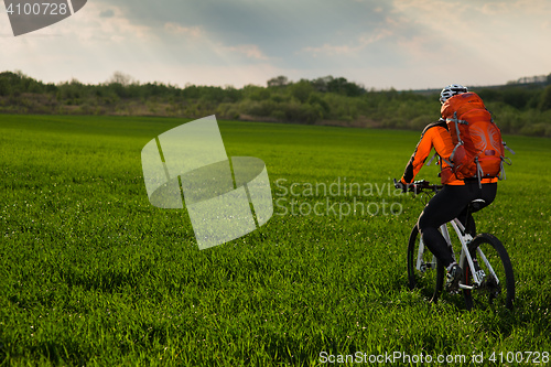 Image of Young man is riding bicycle outside. Healthy Lifestyle.