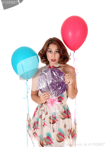 Image of Beautiful woman with lollypop and balloons.