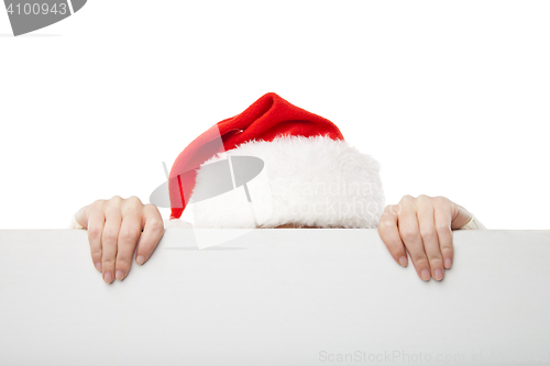 Image of Christmas woman in santa hat holding empty board