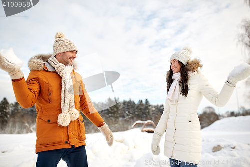 Image of happy couple playing snowballs in winter