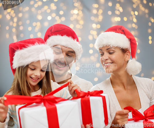 Image of happy family with christmas gift boxes