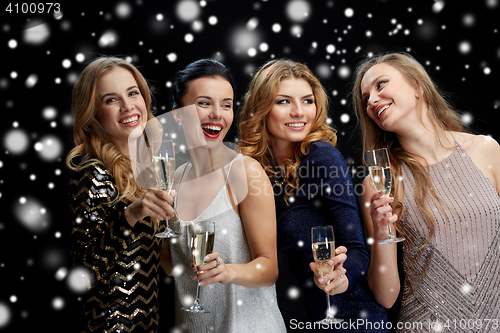 Image of happy women with champagne glasses over black