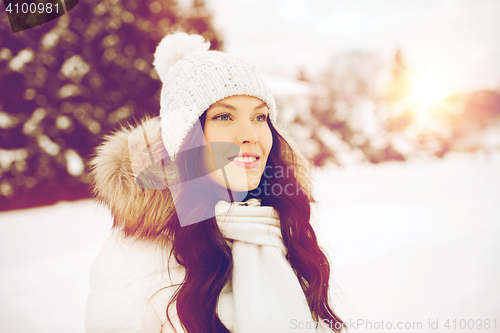 Image of happy woman outdoors in winter clothes